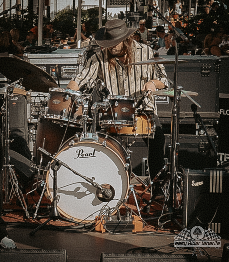 A man is playing drums on a pearl drum set