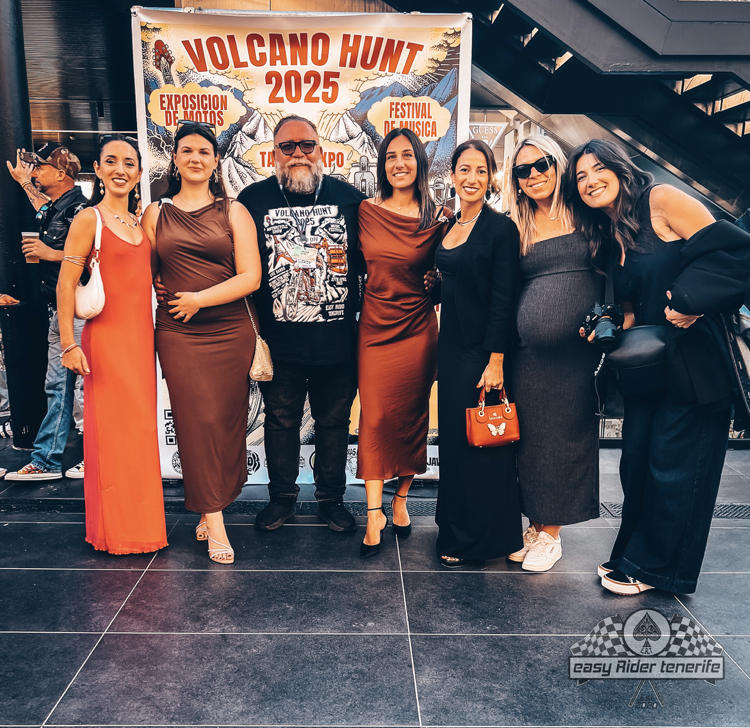 A group of people standing in front of a sign that says volcano hunt 2025