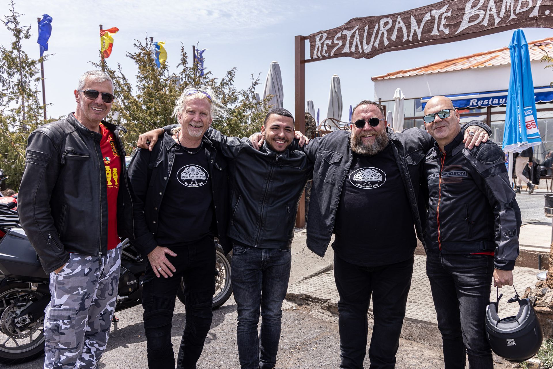A group of men are posing for a picture in front of a restaurant
