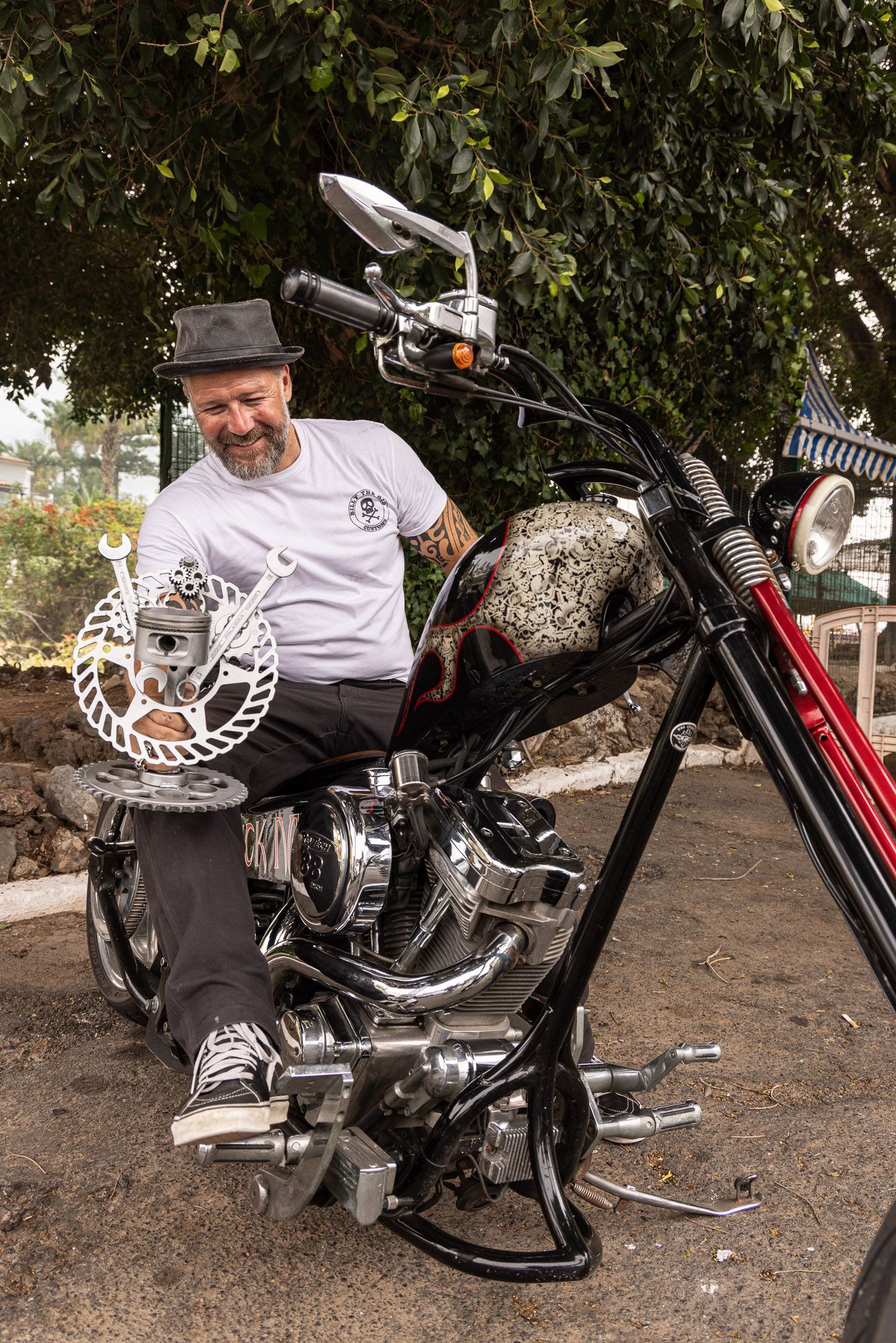 A man is sitting on a motorcycle holding a disc brake.