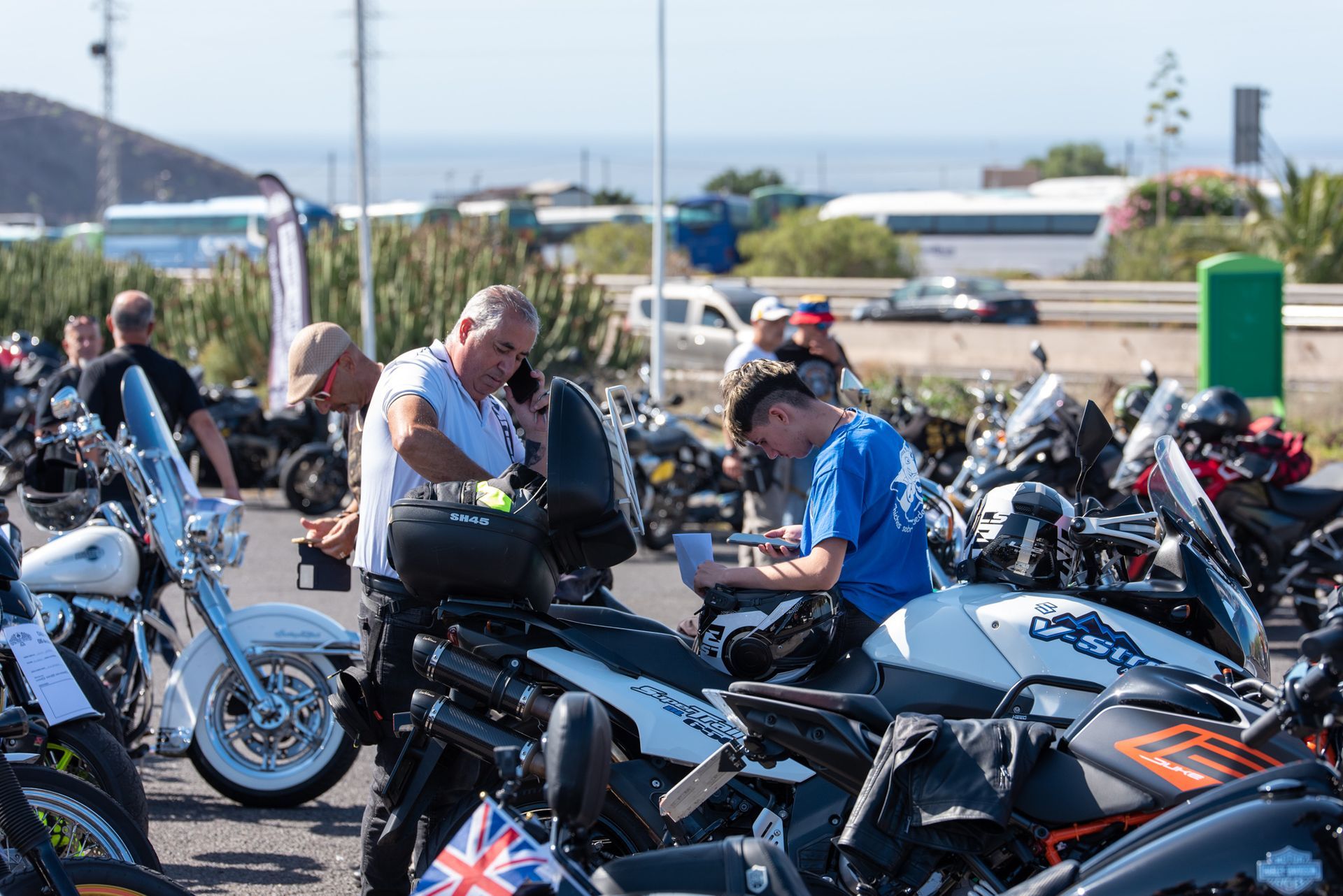 A group of men are sitting on motorcycles in a parking lot.