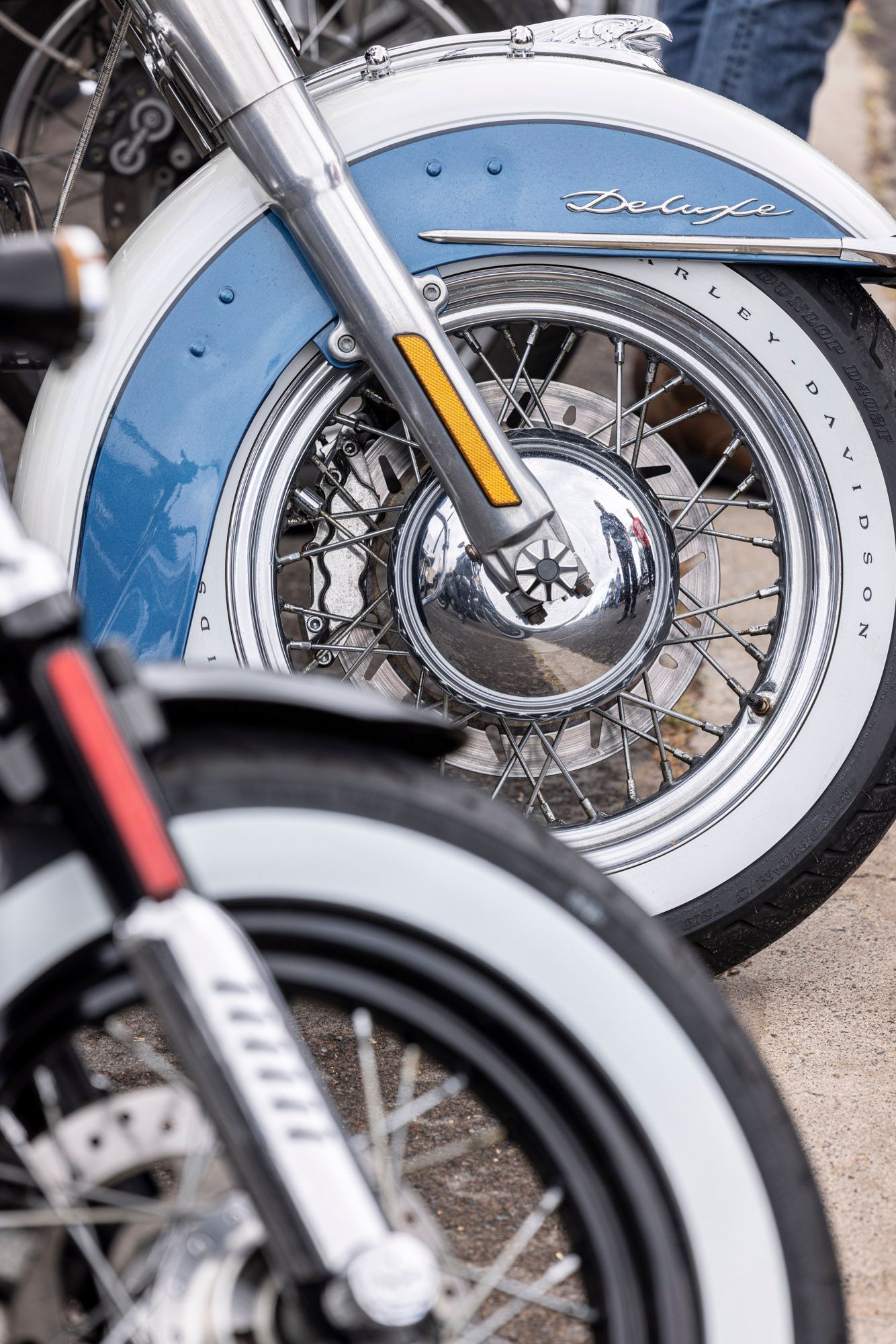 Two motorcycles are parked next to each other on the side of the road.