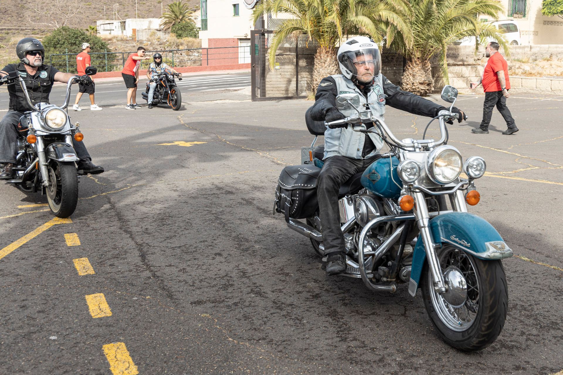 A group of people are riding motorcycles down a street.