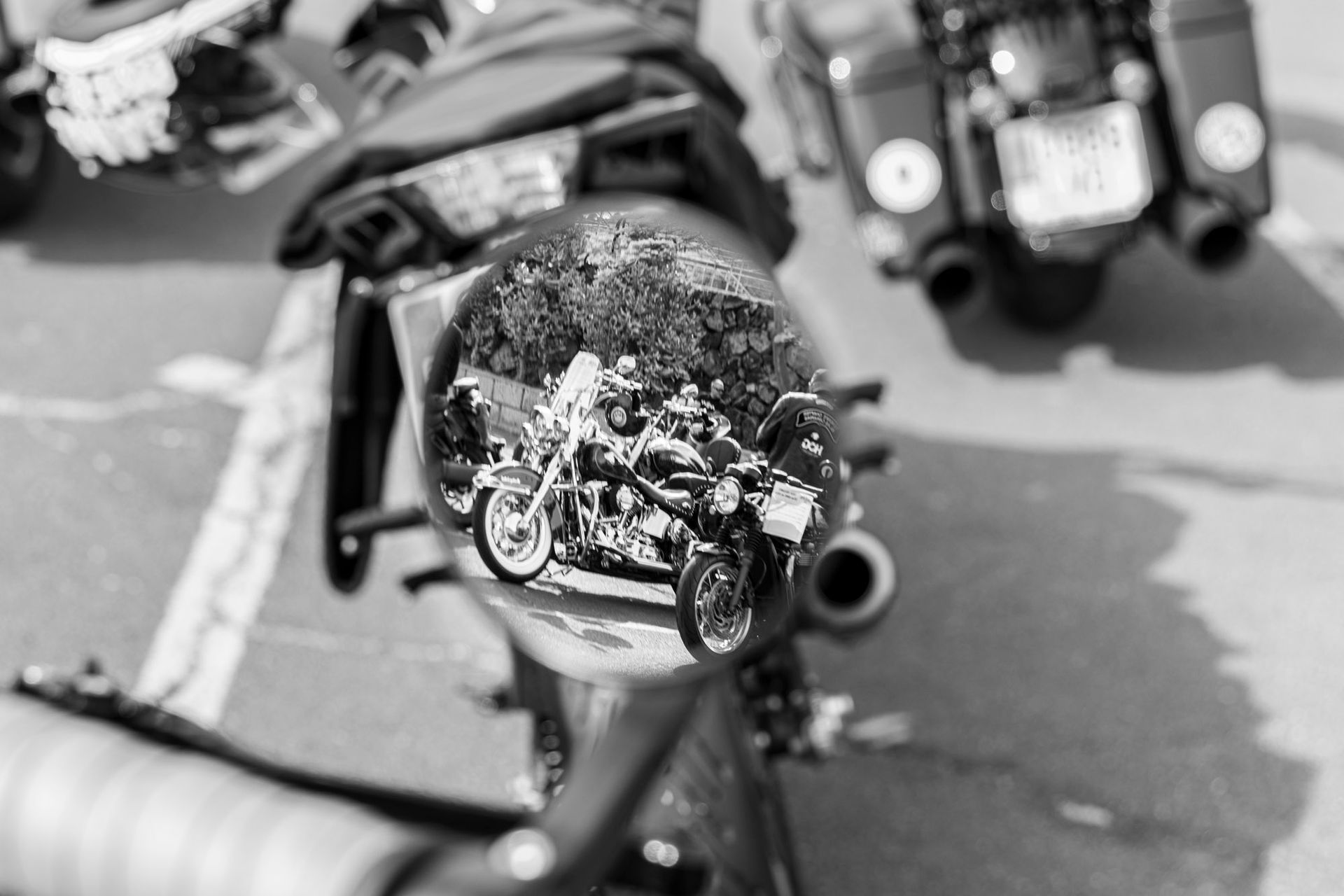 A black and white photo of a person riding a motorcycle.