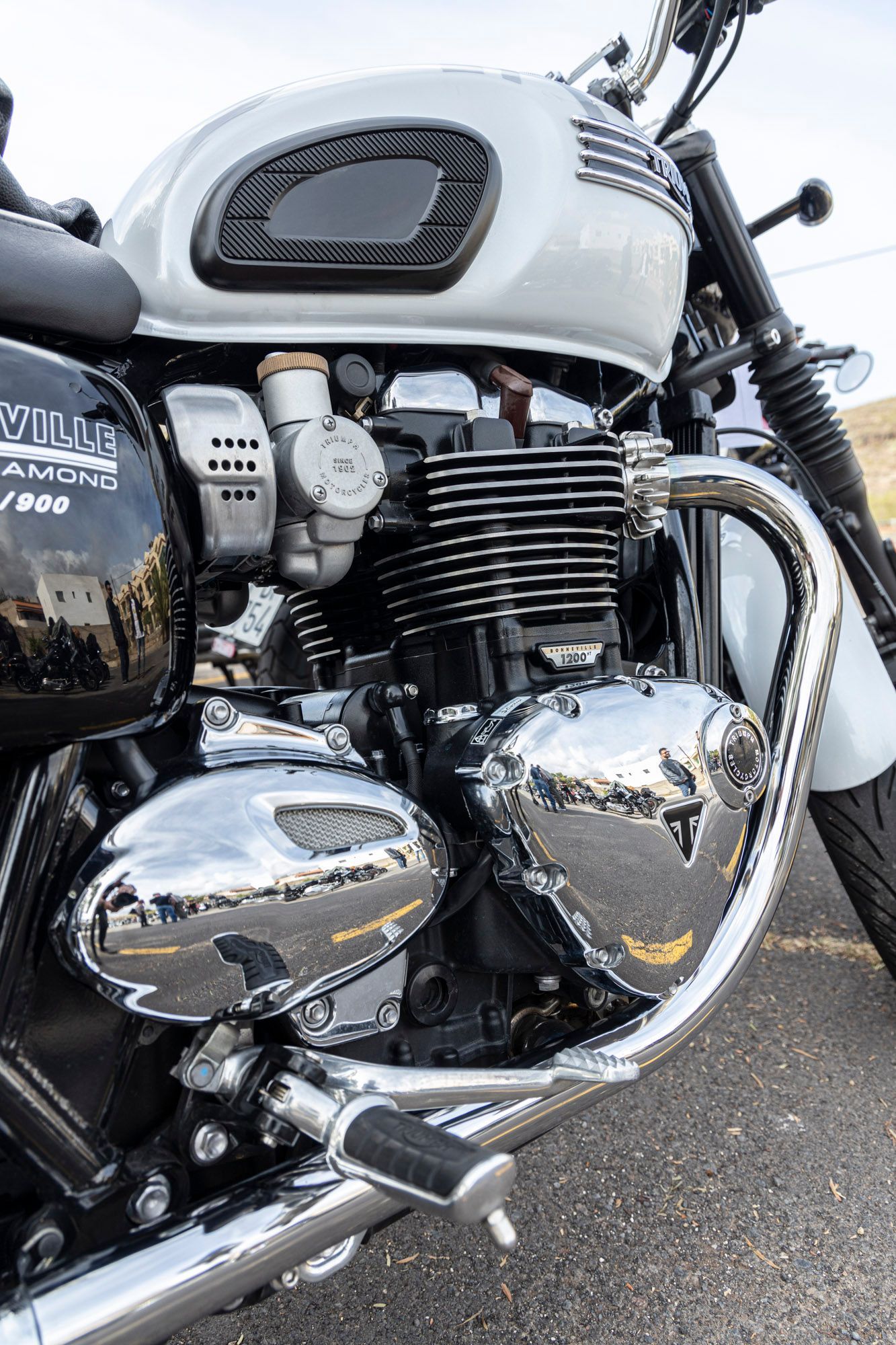 A close up of a motorcycle engine on a road.