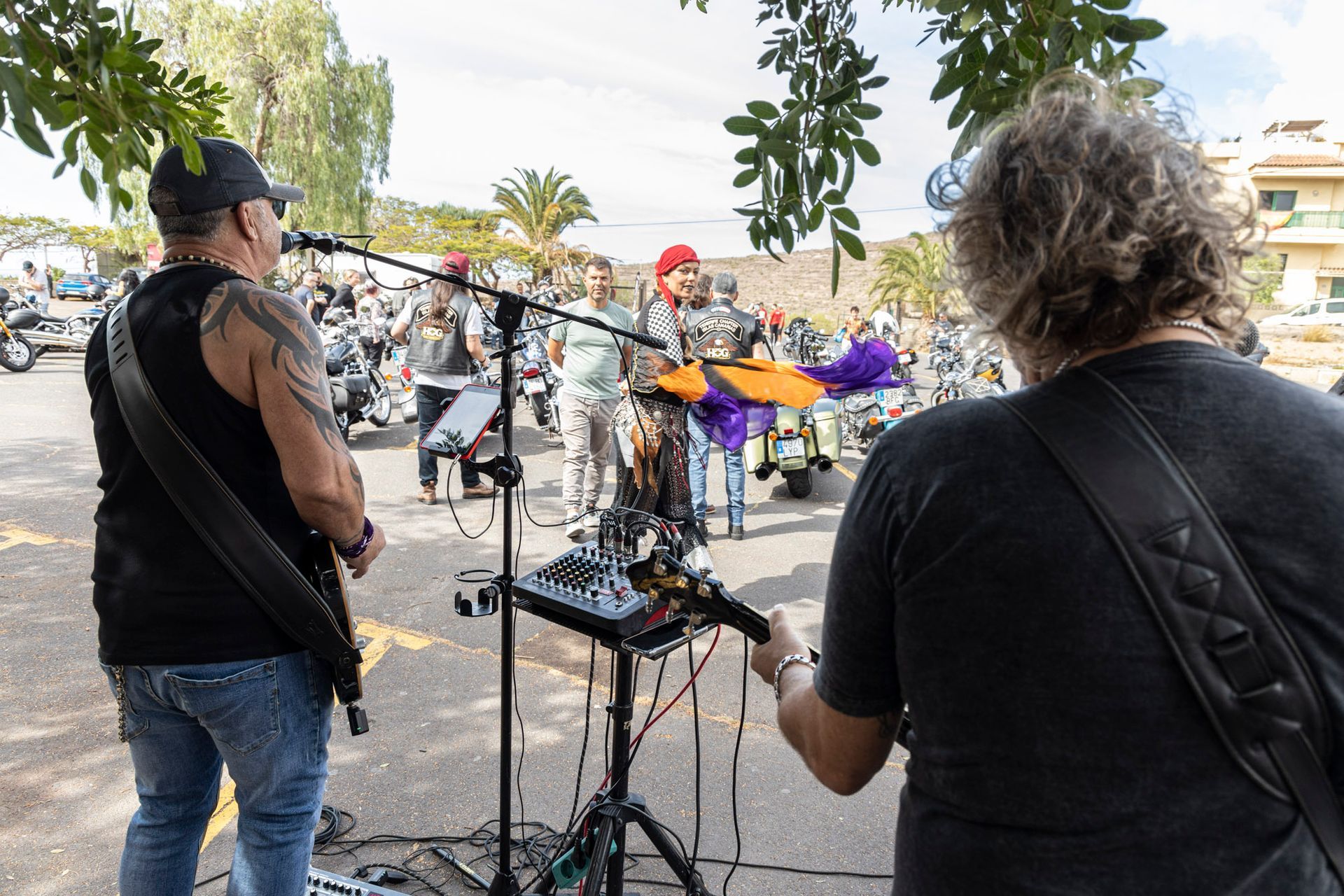 A man is playing a guitar in front of a crowd of people.