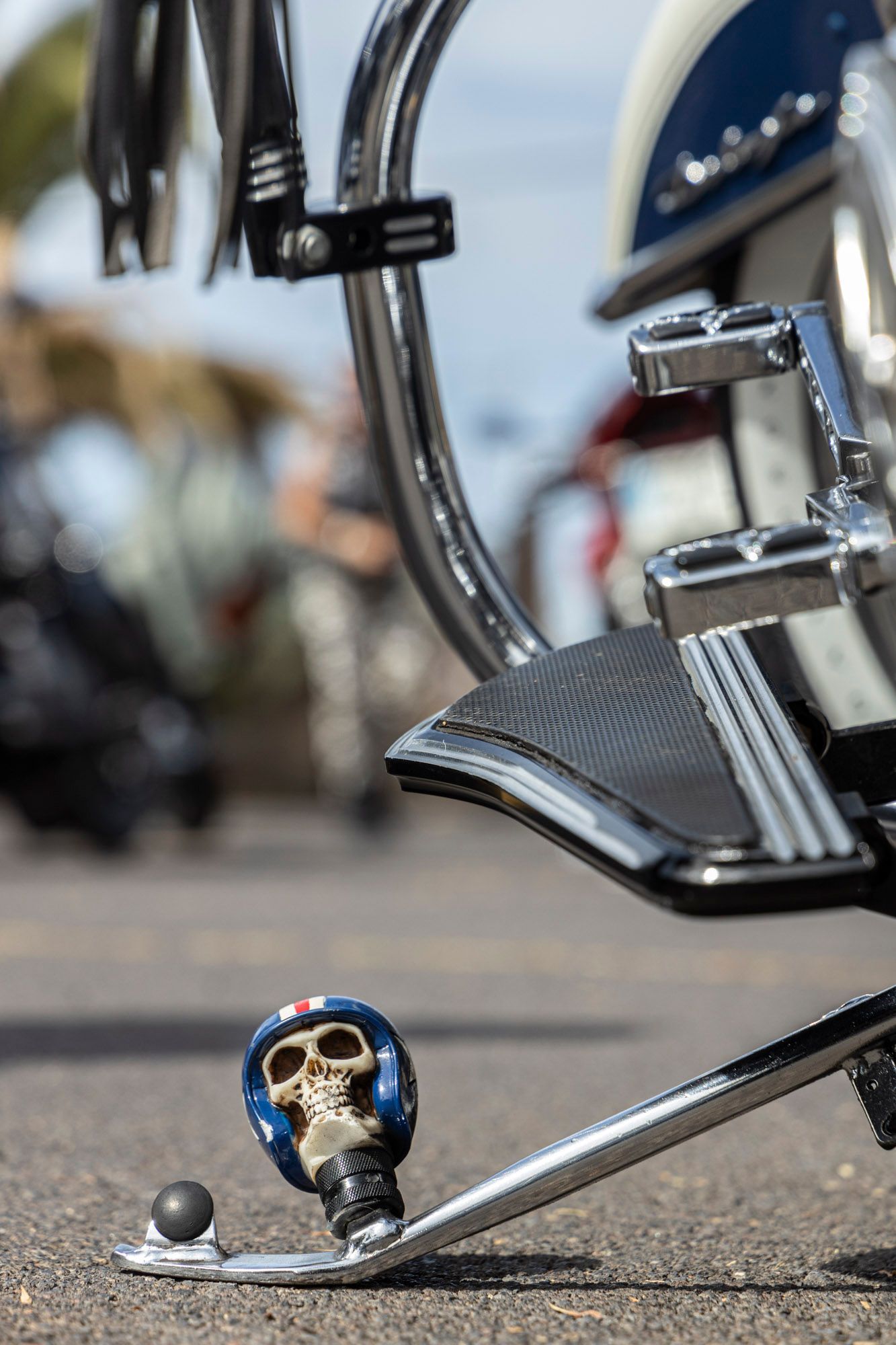 A close up of a motorcycle pedal with a skull on it.