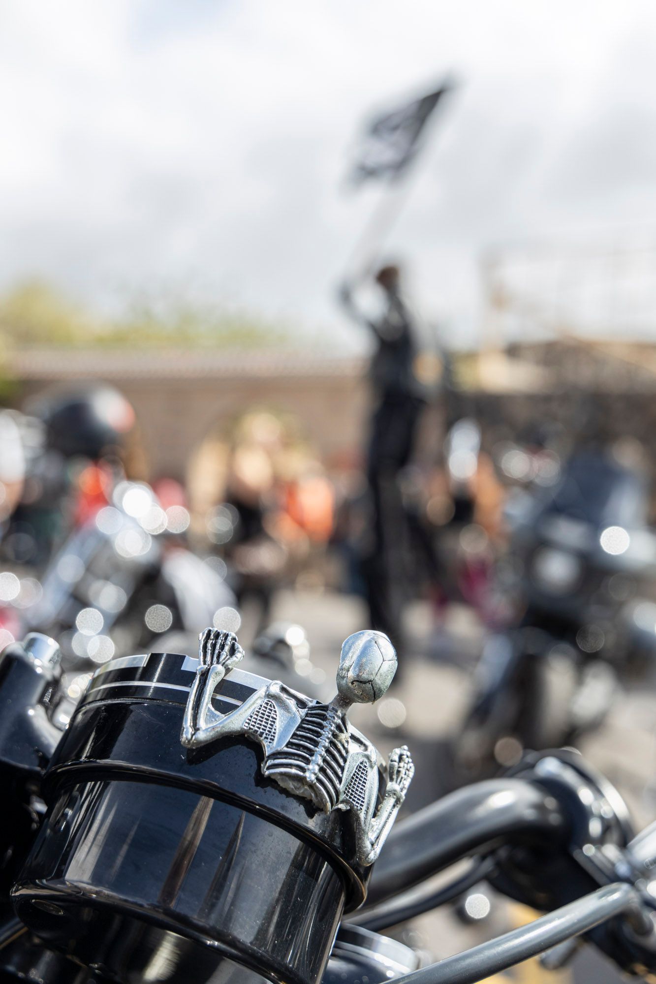 A close up of a motorcycle with a skull on the handlebars
