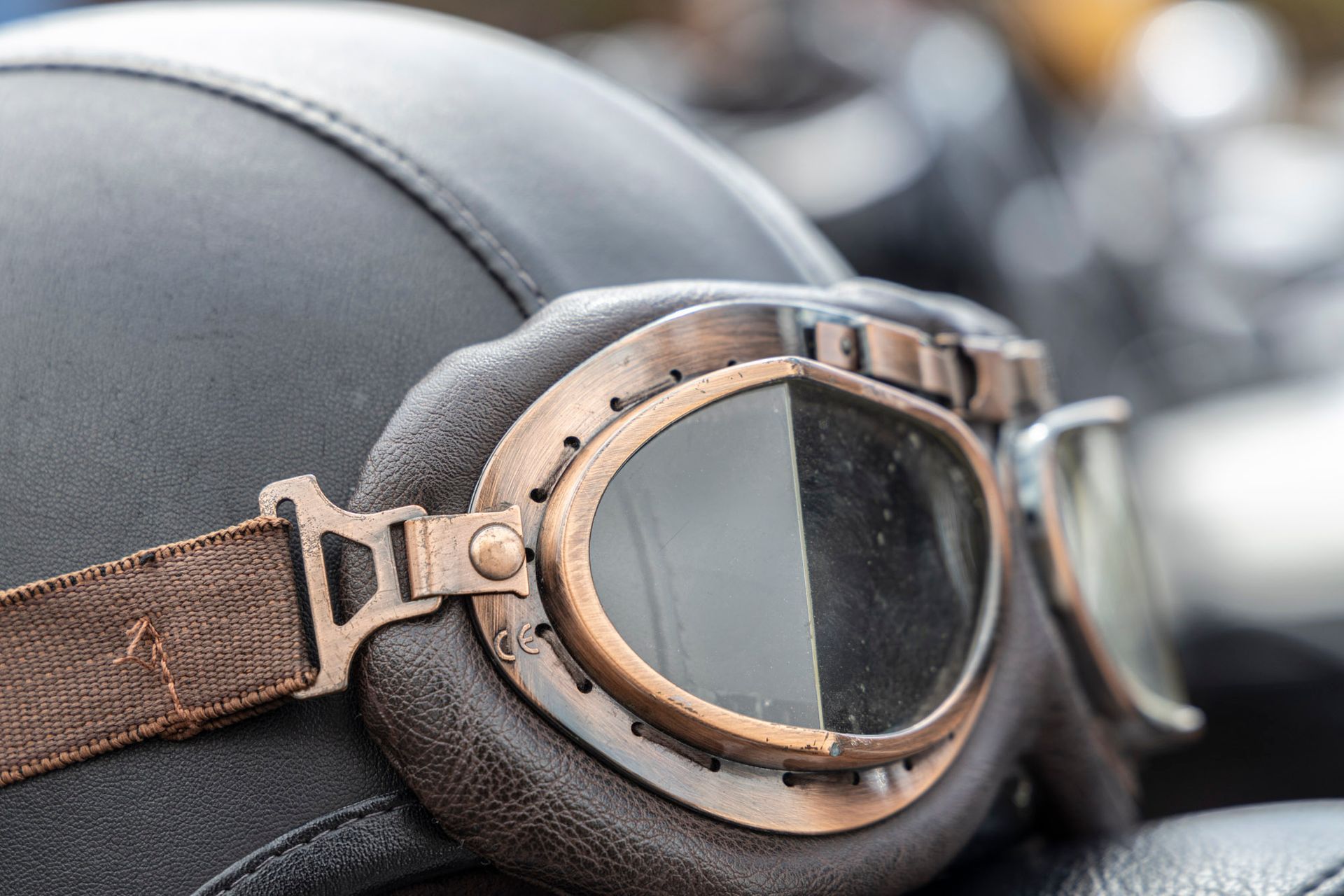 A close up of a helmet and goggles on a motorcycle