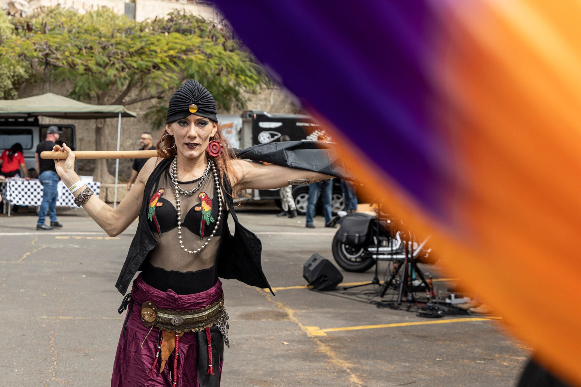 A woman in a costume is dancing in a parking lot.