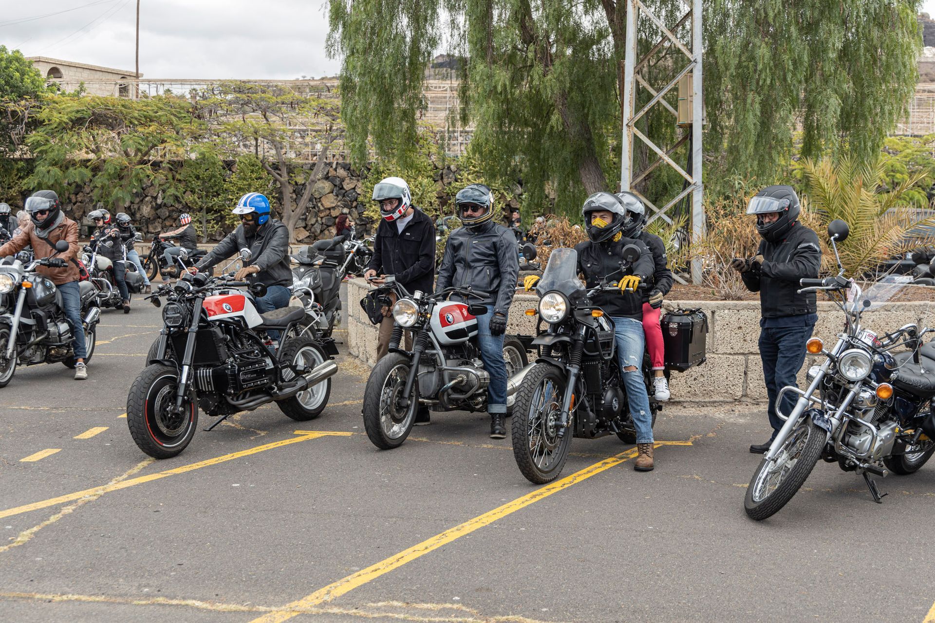 A group of people are riding motorcycles down a street.