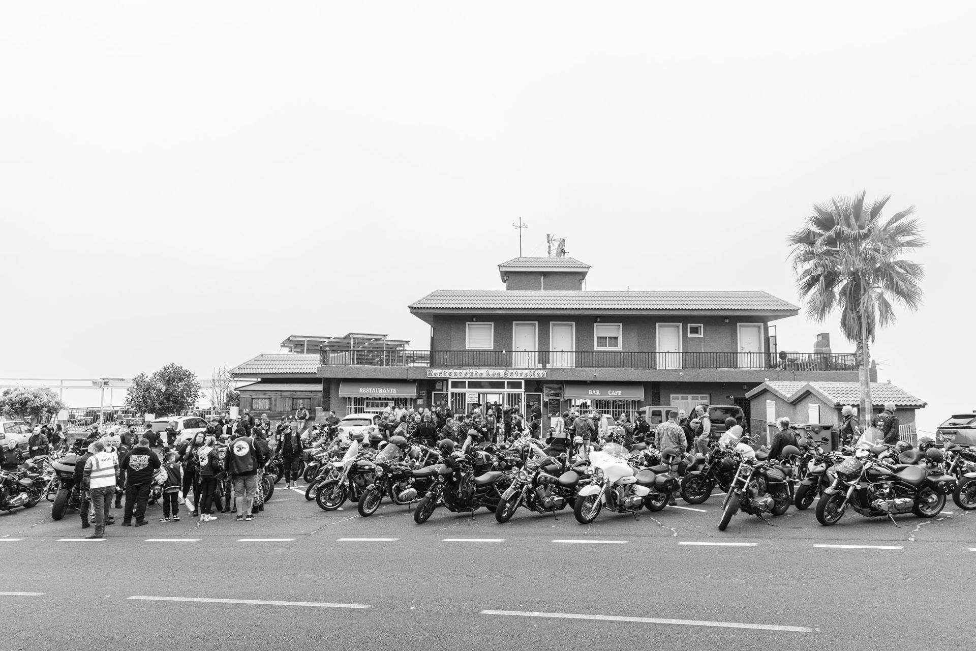 A group of motorcycles are parked in front of a building