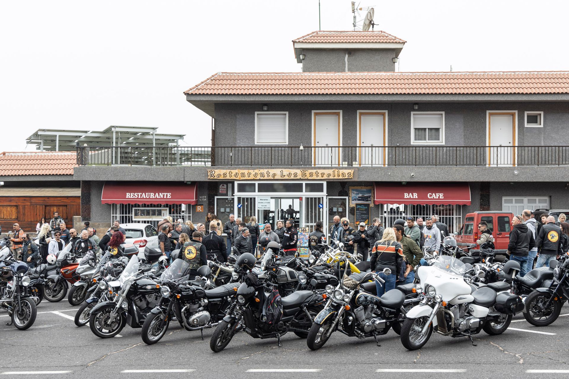 A group of motorcycles are parked in front of a building