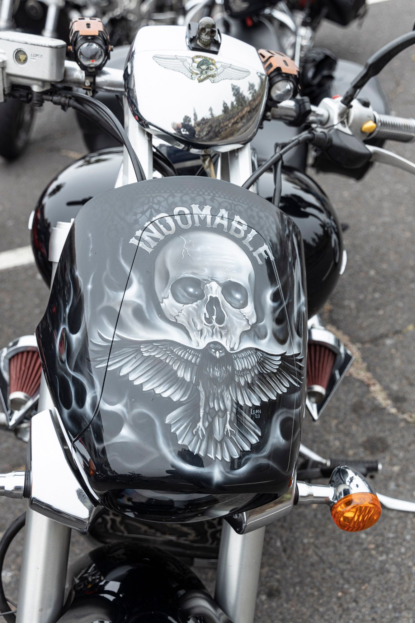 A black motorcycle with a skull on the front