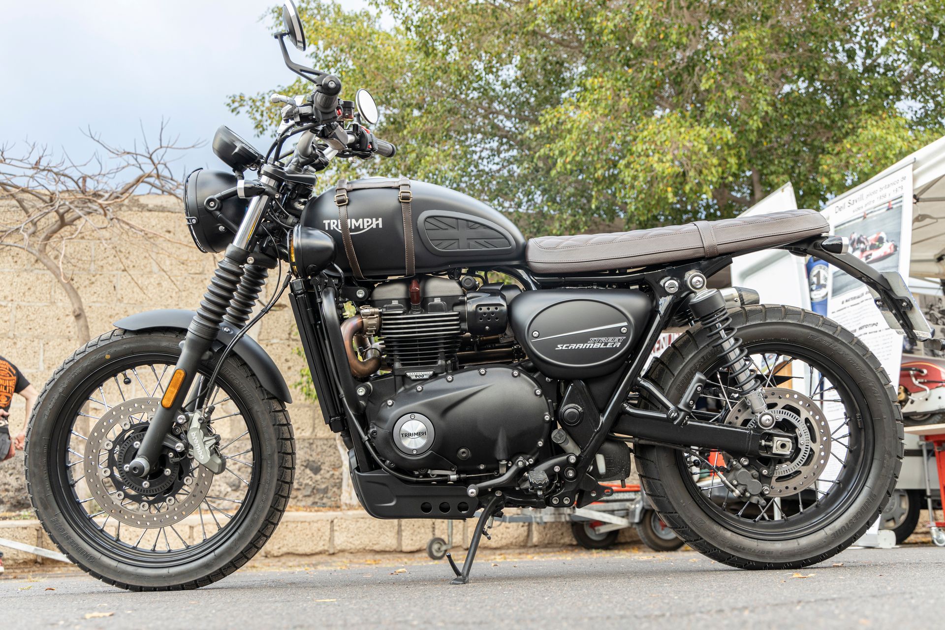 A black motorcycle is parked on the side of the road.