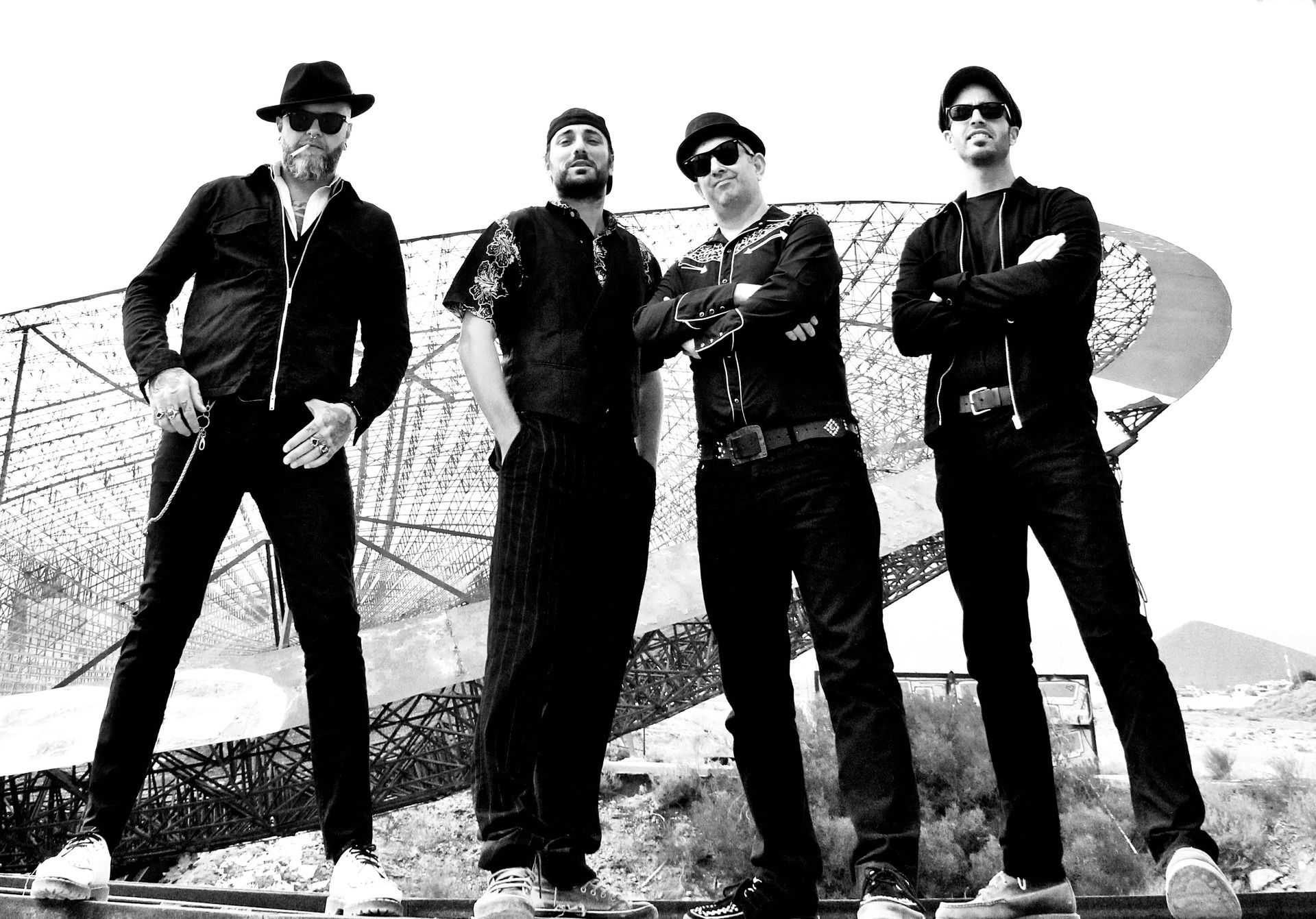 A black and white photo of four men standing next to each other
