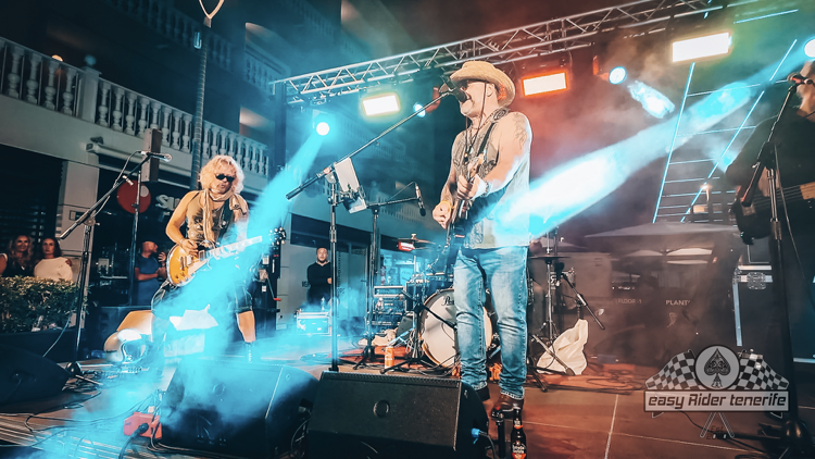 A group of people are standing on a stage playing instruments.