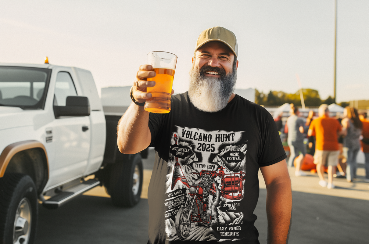 A man with a beard is holding a glass of beer in front of a truck.