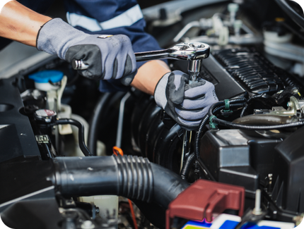 Mechanic using a wrench to repair a car engine in a garage | Hornick's Diesel & Auto Repair