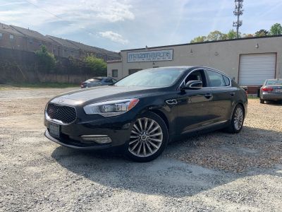 A black car is parked in a gravel | TLS Motorworks