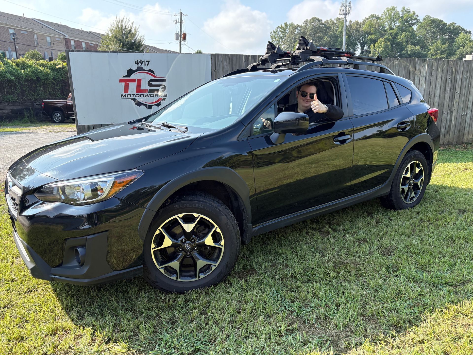 TLS Motorworks emloyee Ian sitting in a subaru crosstrek