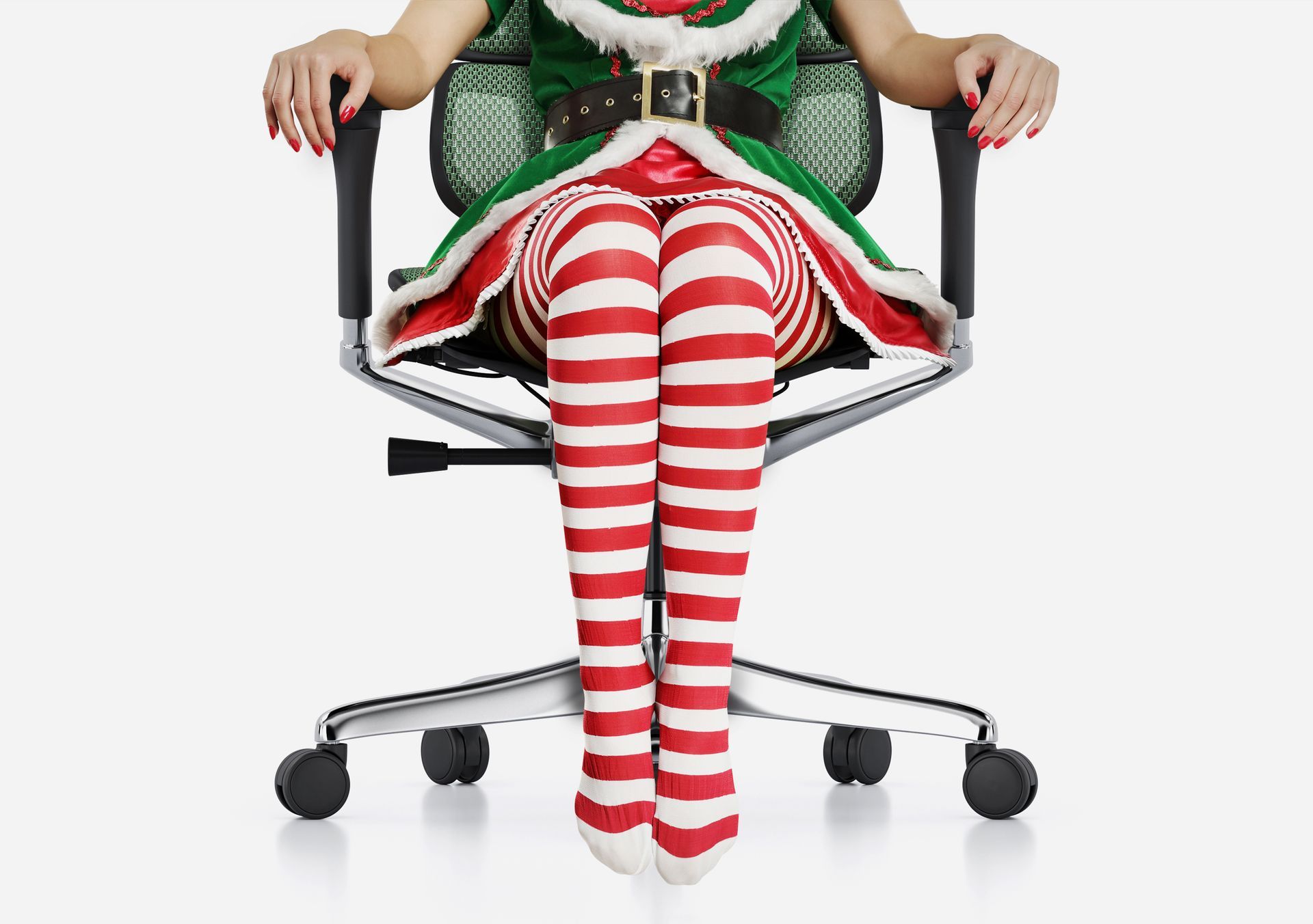 a Christmas elf wearing candy cane tights and a green dress is sitting in a comfort ergohuman chair