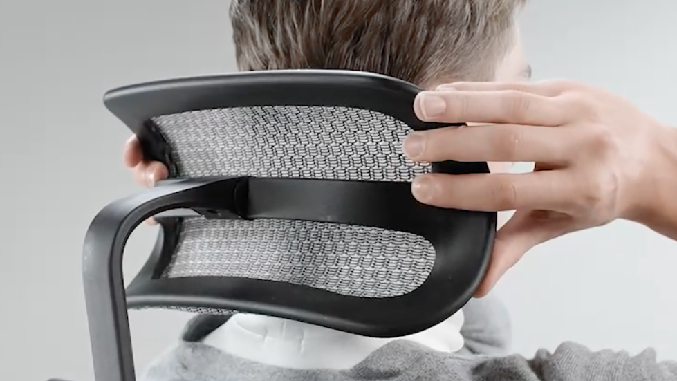 Man adjusting Ergohuman office chair headrest