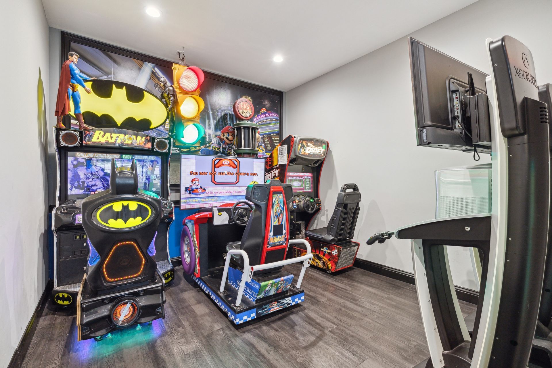 Aqua Dental and Orthodontics in Duncanville, TX. A room with a lot of arcade games and a batman mural on the wall.