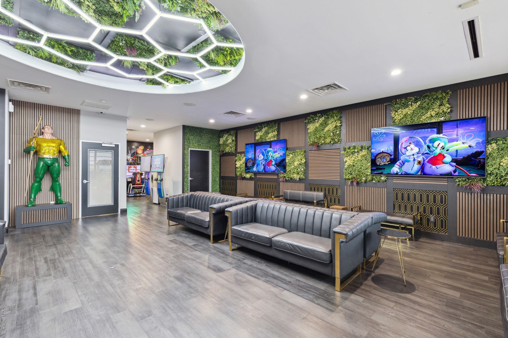 Aqua Dental and Orthodontics in Duncanville, TX. A living room with a couch , chairs , televisions and a statue of aquaman.