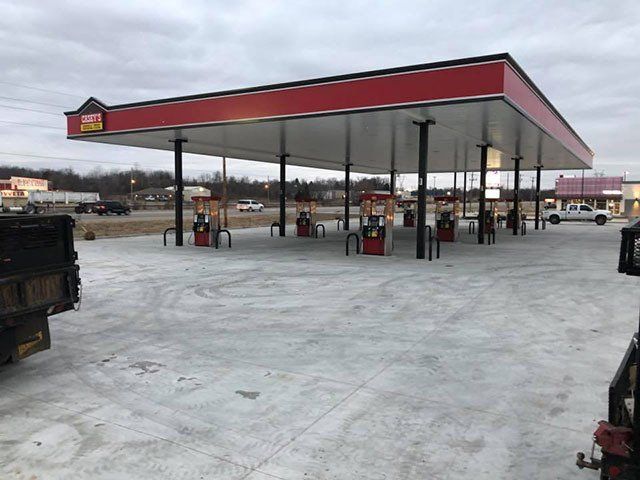 A gas station in the snow with a red roof