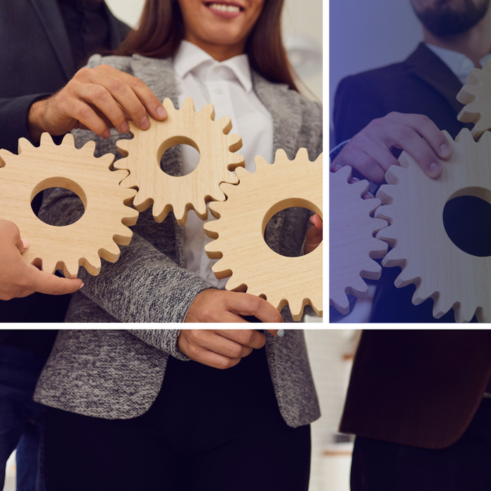 A man and a woman are holding wooden gears in their hands