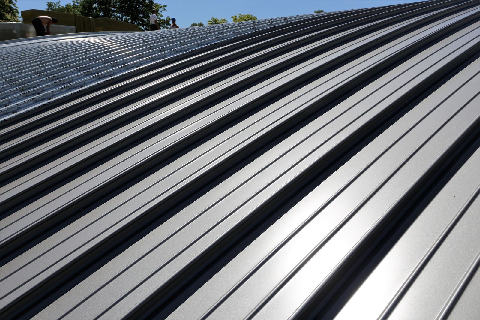 Gray corrugated metal roof reflecting sunlight.