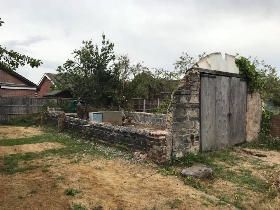 A clear area of patio where a garage once stood