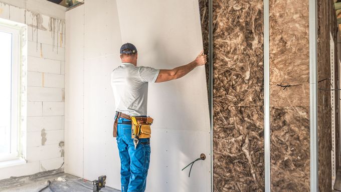 Granite and tile samples leaning against a wall in a renovation area