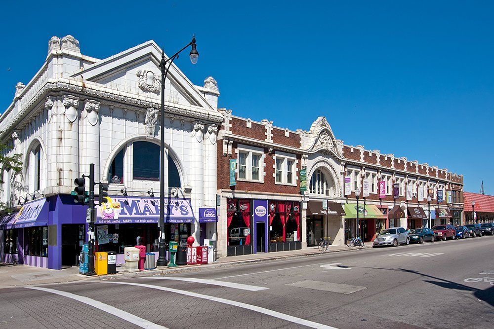 A building with a purple awning that says  Mary's Hamburger on it.