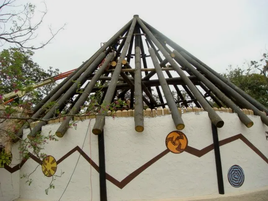 A building with a roof made of wooden sticks