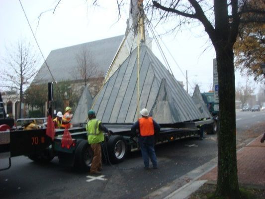 A large pyramid is being lifted by a truck