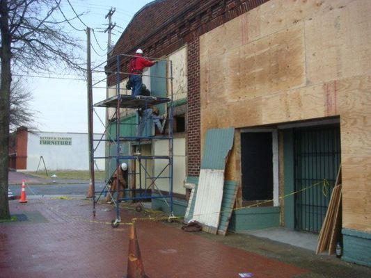 A group of men are working on the side of a building