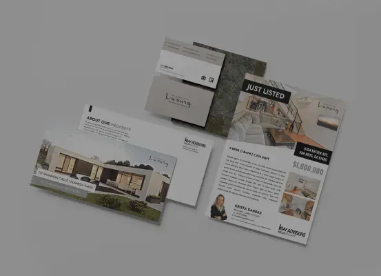 A bunch of real estate cards and envelopes are sitting on a table.