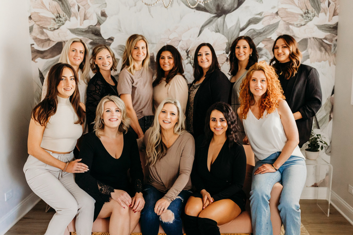 A group of women are posing for a picture together.