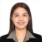 A woman in a suit and collared shirt is smiling for the camera.