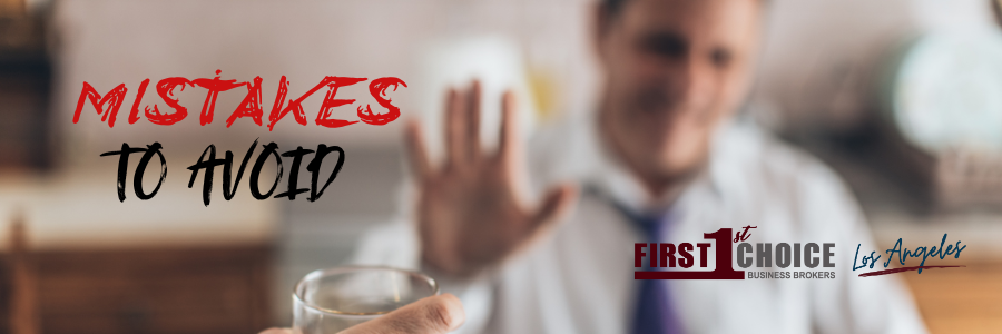 A man is holding a glass of water and refusing to drink it.