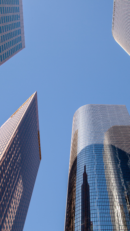 A group of tall buildings against a blue sky