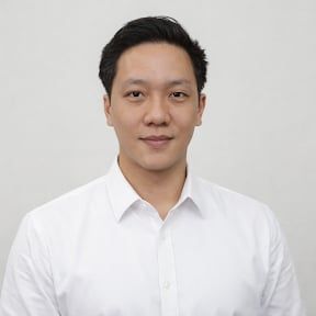 A man in a suit and tie is smiling for the camera