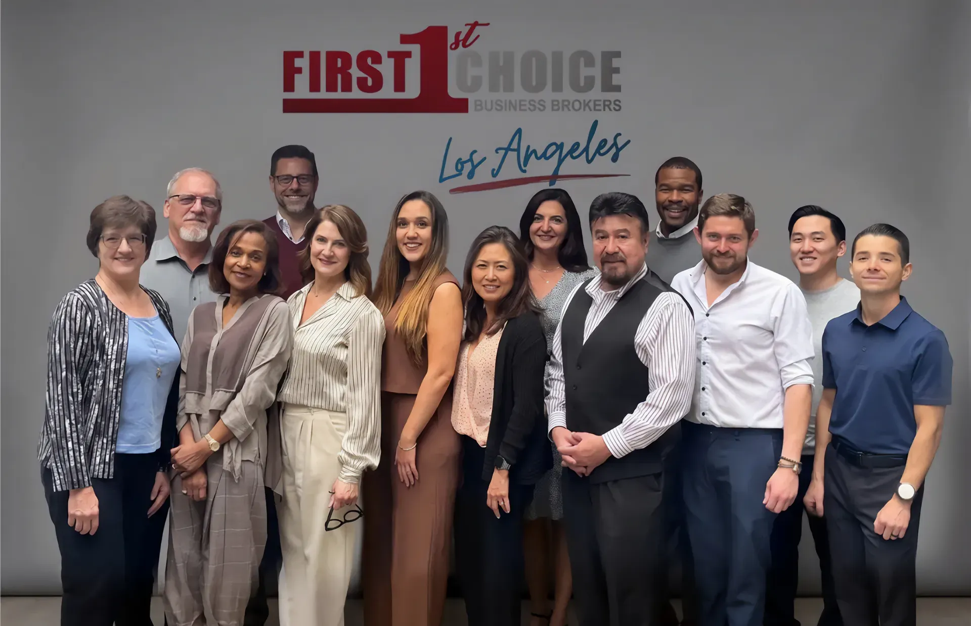 A group of people are posing for a picture in front of a first choice banner.