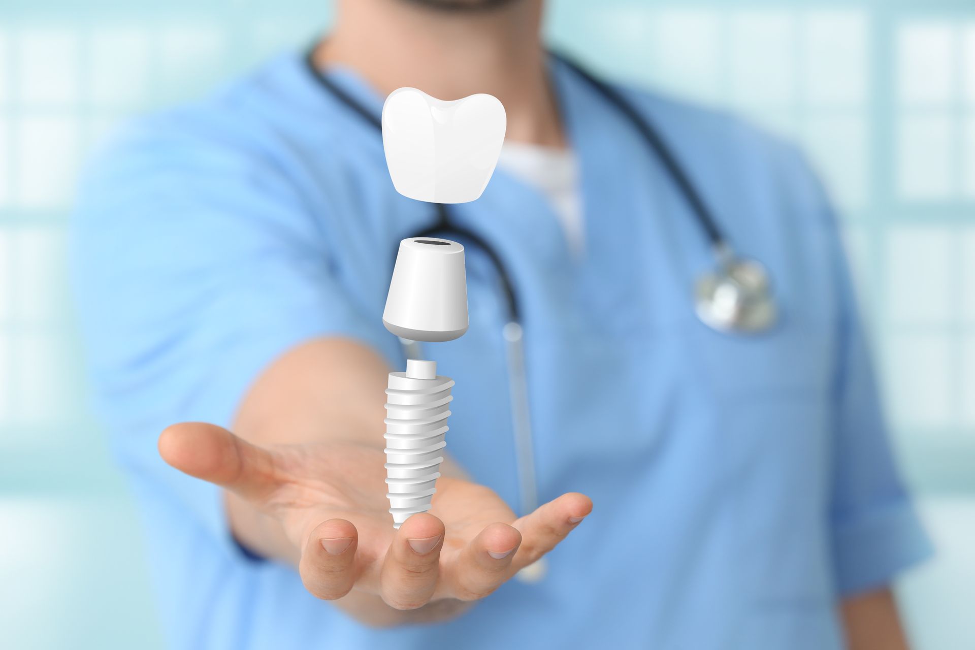 Male dentist with digital model of tooth implant in clinic, close-up.