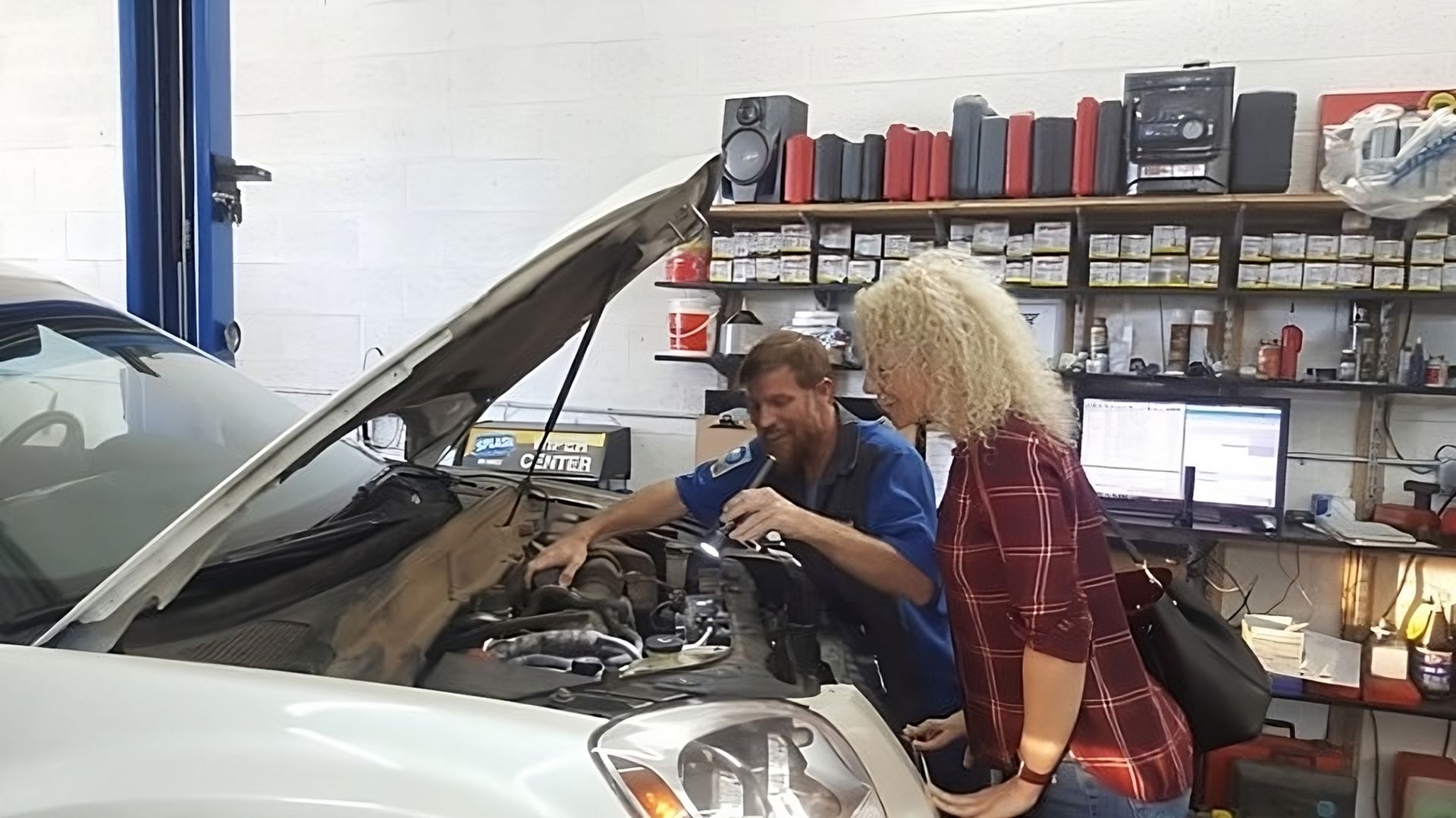 Mechanic showing customer engine
