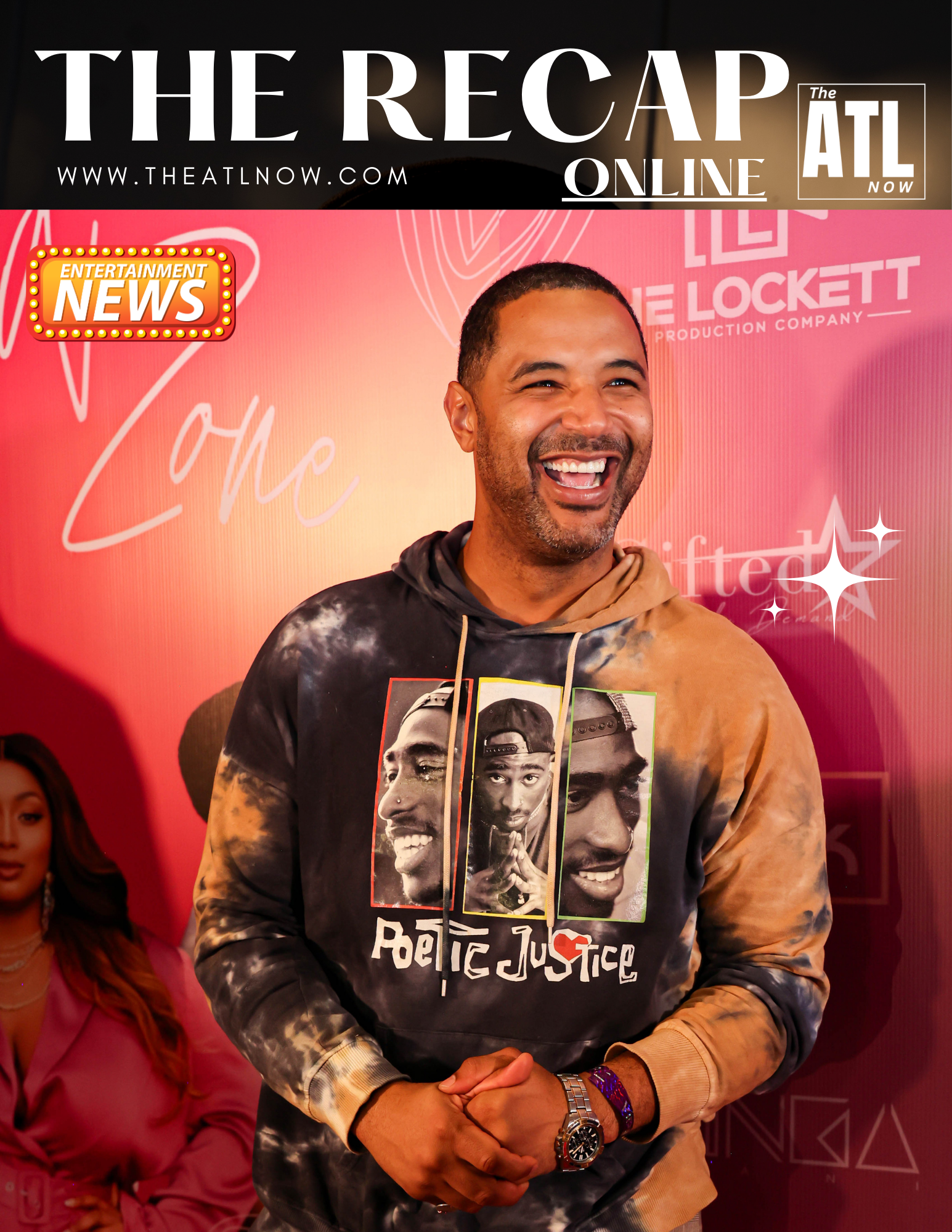 Man smiling on a red carpet at The Recap ATL Online event, wearing a black graphic hoodie.