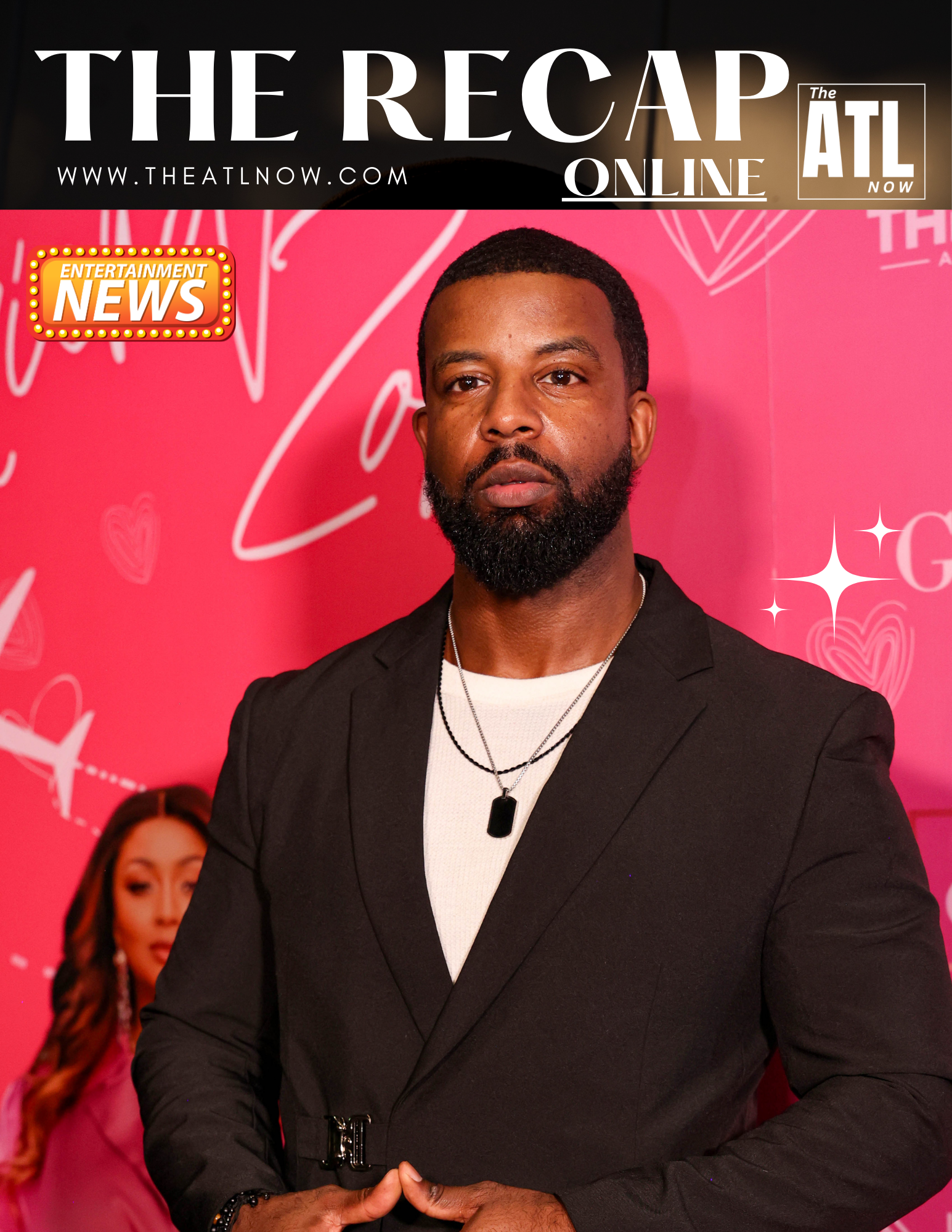 Man in black suit posing at The Recap ATL event against a pink backdrop