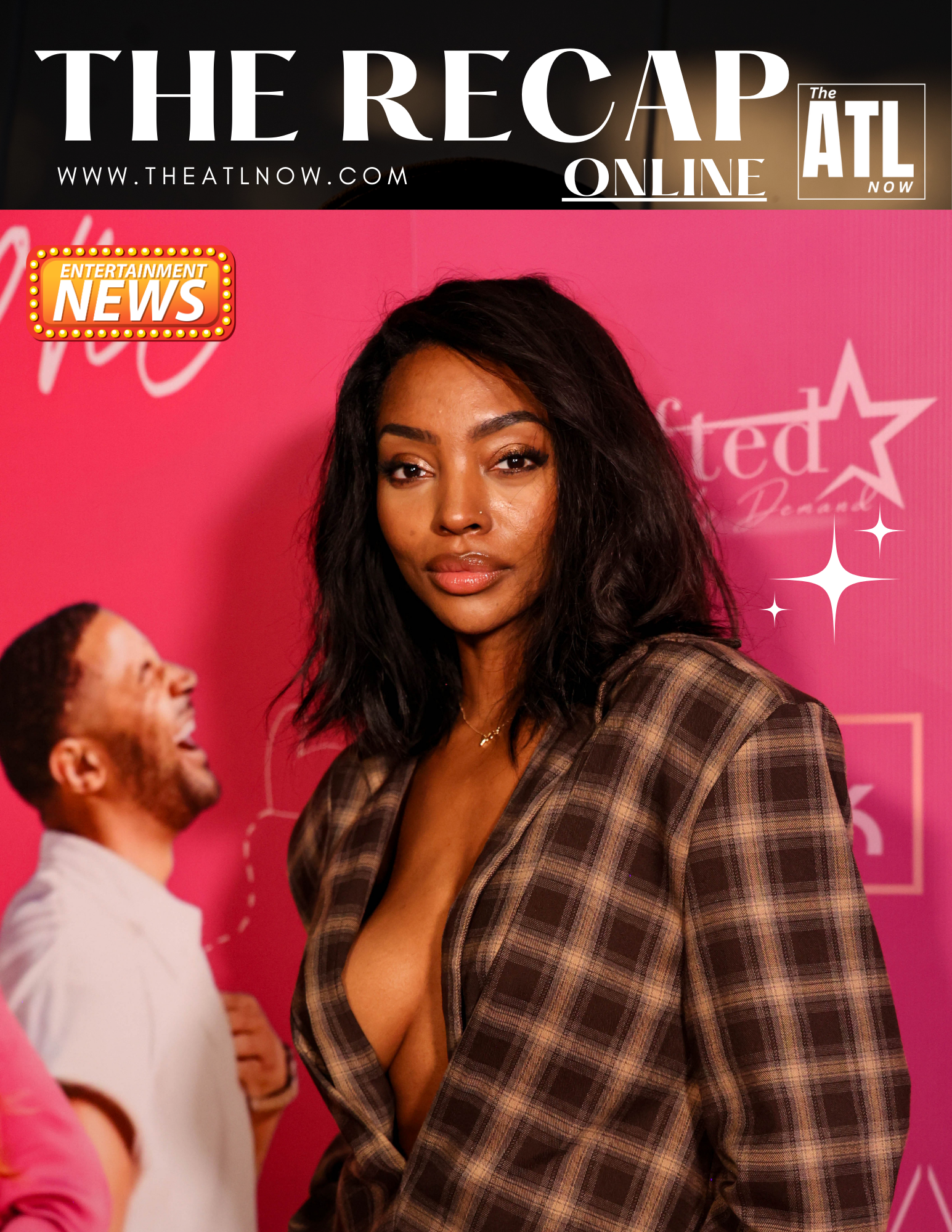 Woman posing on a pink red-carpet backdrop at The Recap ATL event, wearing a plaid deep-V blazer.